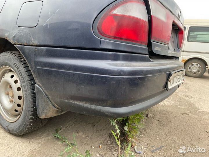 Бампер задний Mazda Familia седан 1997