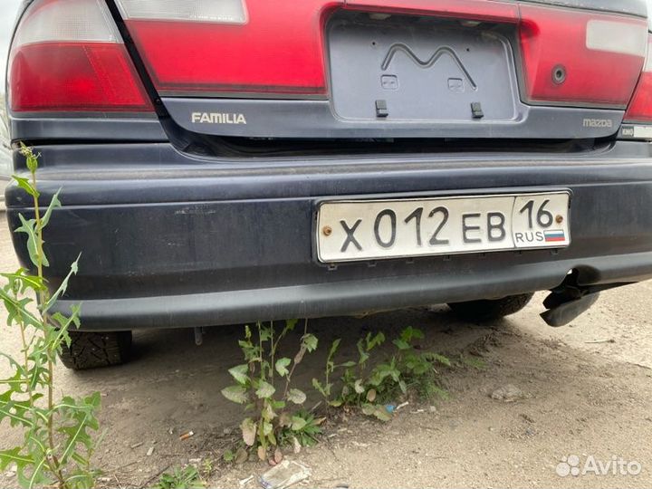 Бампер задний Mazda Familia седан 1997