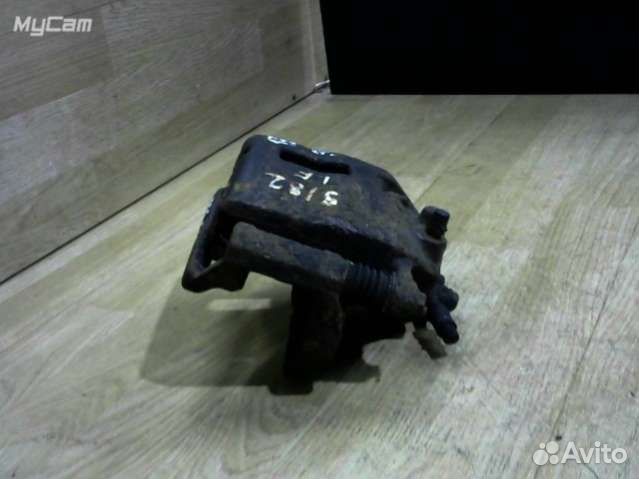 Суппорт тормозной передний левый Nissan Almera Tin