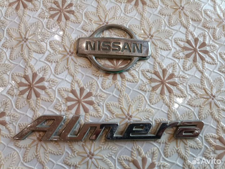 Эмблема nissan almera
